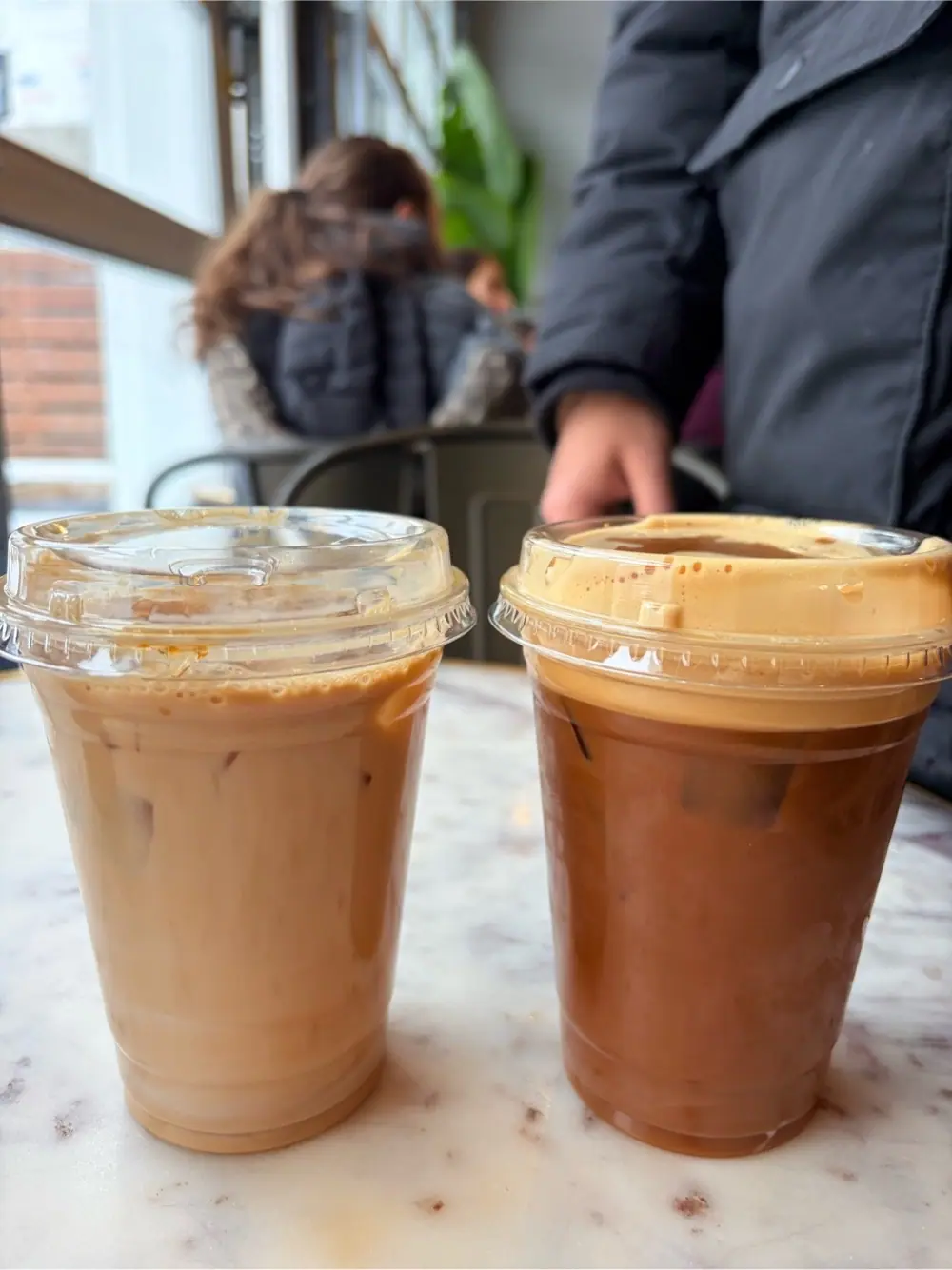 Nitro cold brew with madeleine syrup & a splash of whole milk at Café Liv